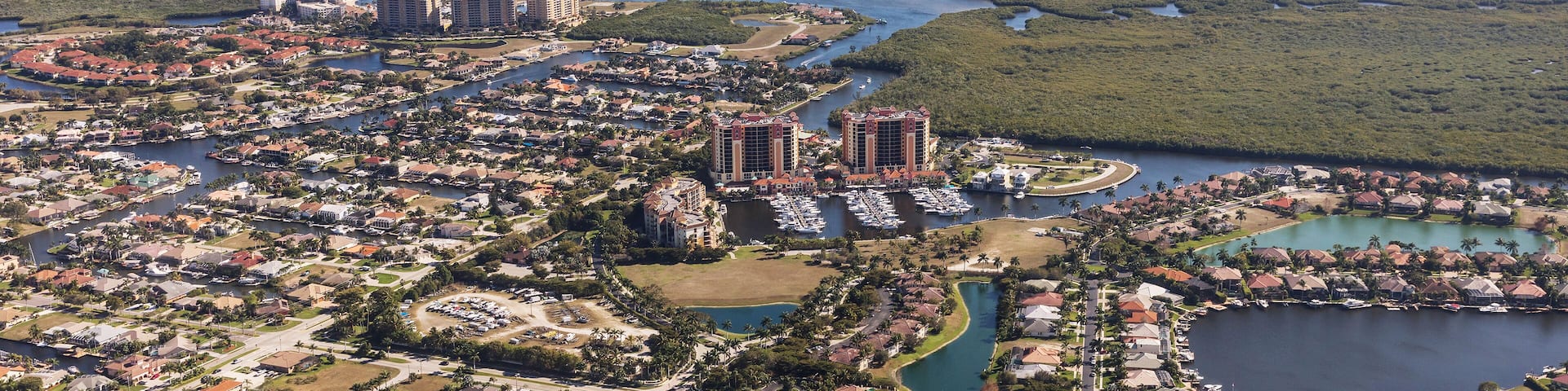 Aerial view of city and gulf Cape Coral, Florida. Typical architecture of South Florida. Large houses built on the banks of canals, canals into the sea.