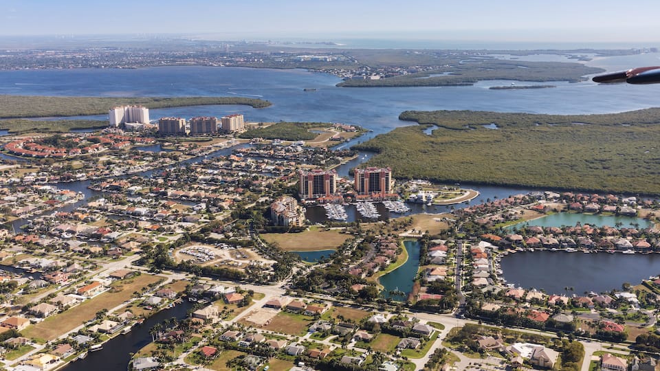 Aerial view of city and gulf Cape Coral, Florida. Typical architecture of South Florida. Large houses built on the banks of canals, canals into the sea.