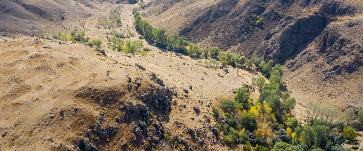 Aerial view of Armenian semiarid landscape nearby Carahunge (Zorats Karer) prehistoric archaeological site on sunny autumn day. Sisian, Syunik Province, Armenia.