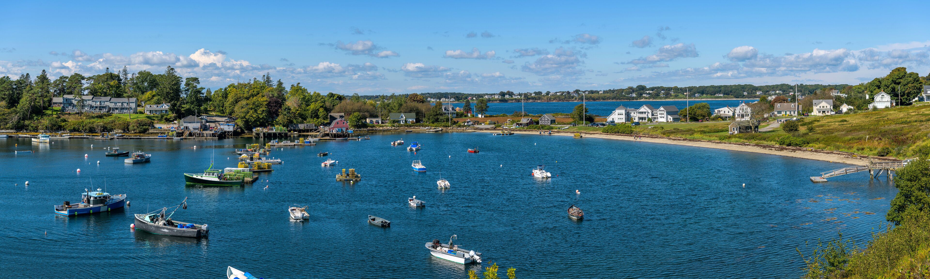 Mackerel Cove - A panoramic overview of lobster boats resting in Mackerel Cove at tip of Bailey Island on a sunny Autumn morning. Bailey Island, Harpswell, Maine, USA. 