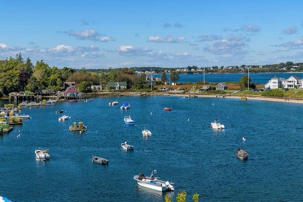 Mackerel Cove - A panoramic overview of lobster boats resting in Mackerel Cove at tip of Bailey Island on a sunny Autumn morning. Bailey Island, Harpswell, Maine, USA.