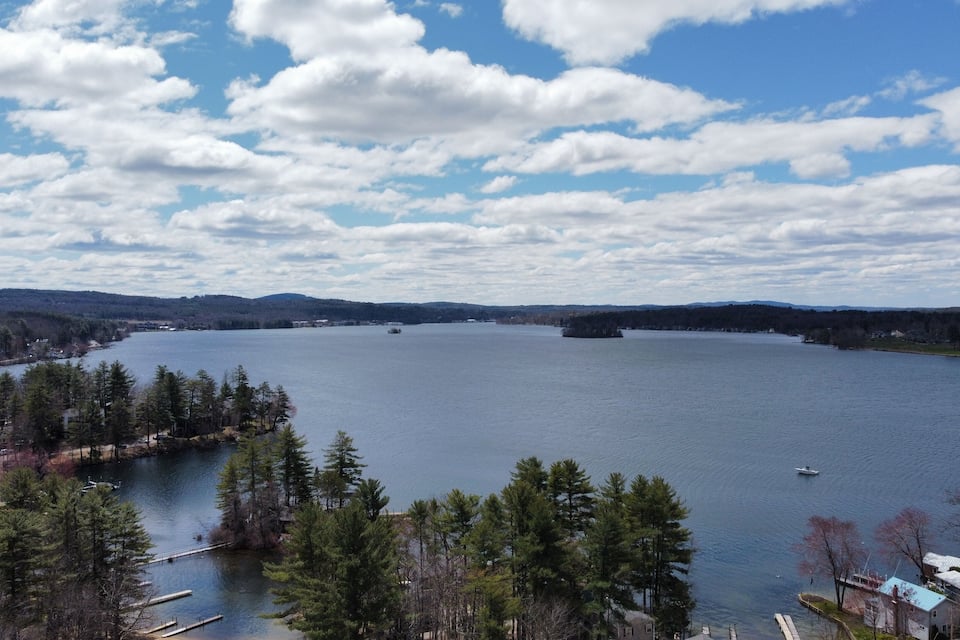 A large lake surrounded by trees and houses.