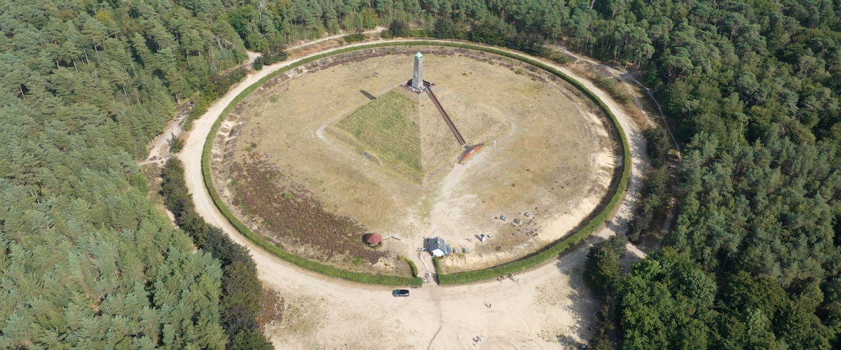 The Pyramid of Austerlitz monument consisting of a grass clad pyramid shaped sand mound stone obelisk. Utrecht municipality of Woudenberg. Aerail drone overview panorma platform.