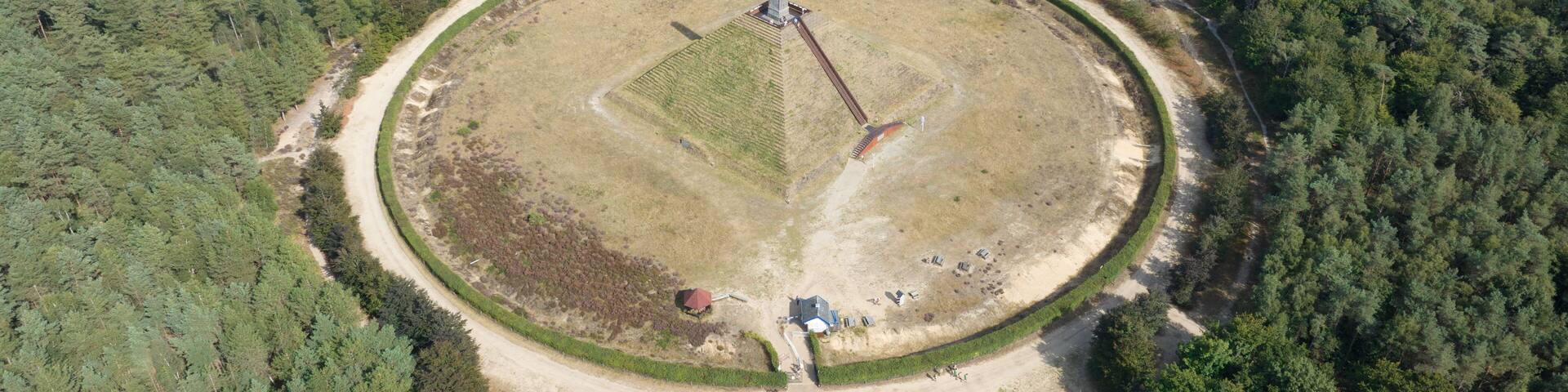 The Pyramid of Austerlitz monument consisting of a grass clad pyramid shaped sand mound stone obelisk. Utrecht municipality of Woudenberg. Aerail drone overview panorma platform.
