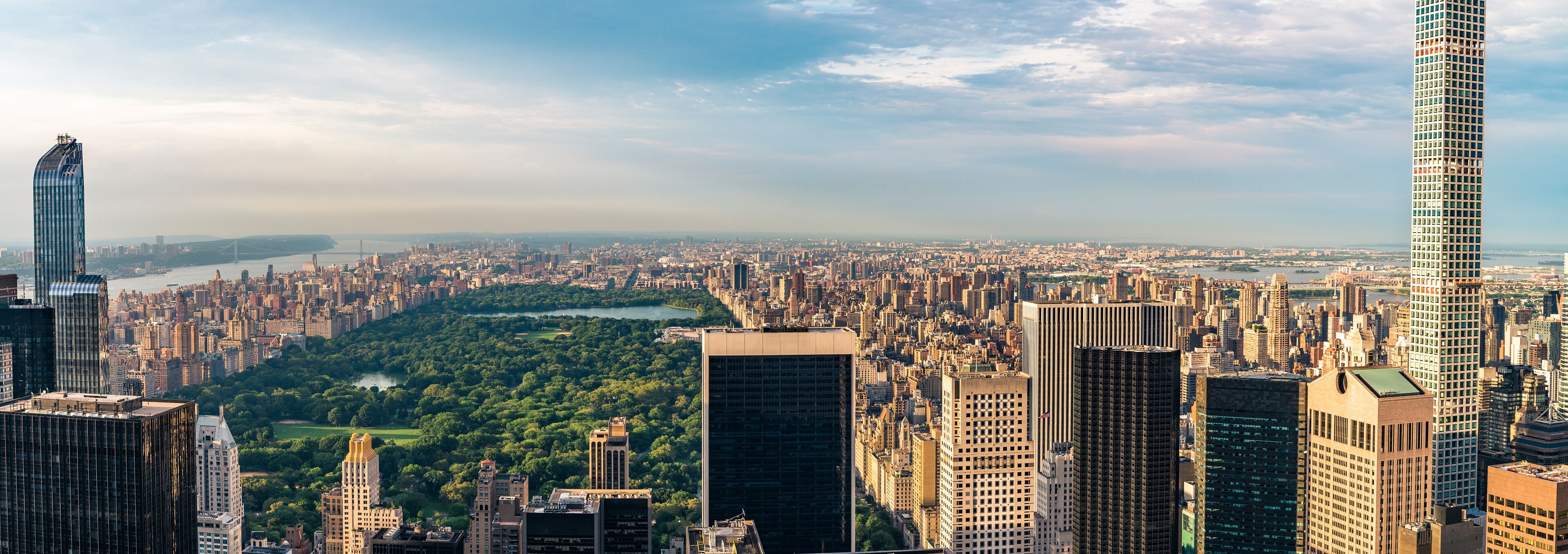 Panorama cityscape view on Central Park, New York, seen from the Rockefeller building "Top of the Rocks" before summer sunset.