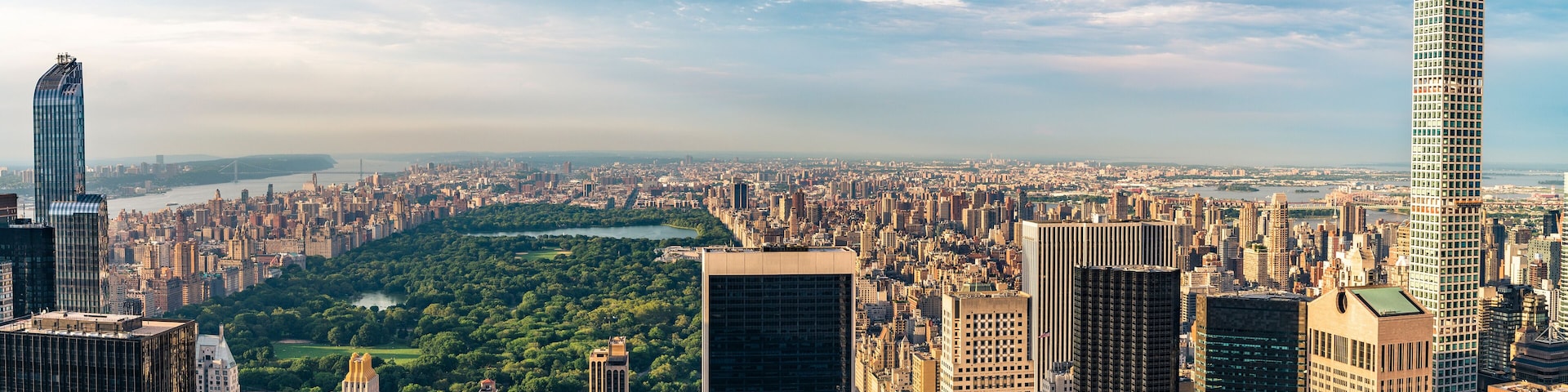 Panorama cityscape view on Central Park, New York, seen from the Rockefeller building "Top of the Rocks" before summer sunset.