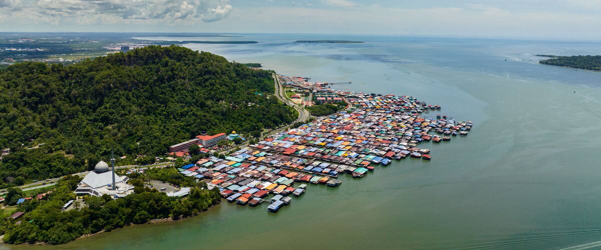 Top view of fishing village with wooden houses on stilts in the sea. Sandakan, Borneo. Malaysia.