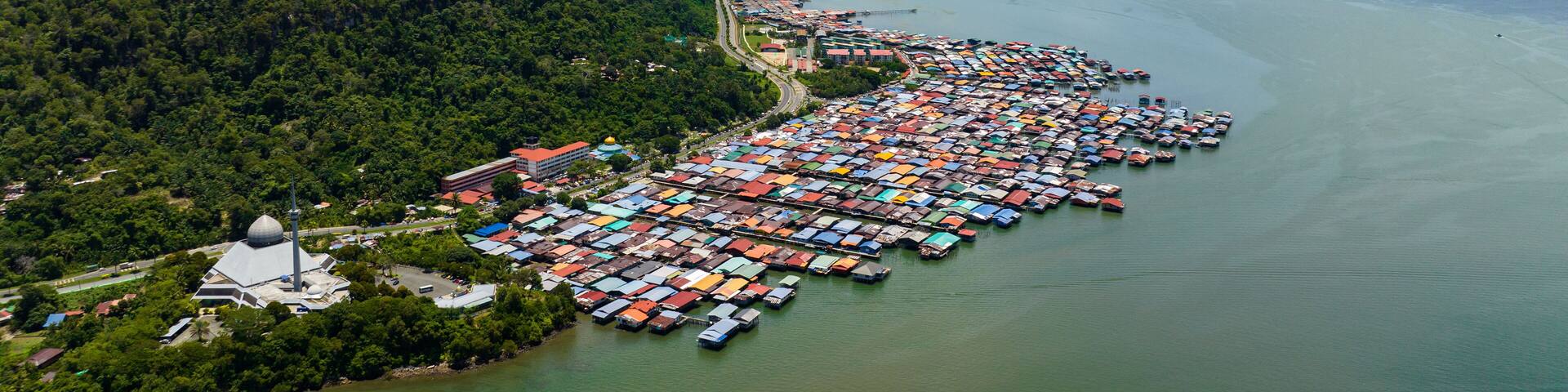 Top view of fishing village with wooden houses on stilts in the sea. Sandakan, Borneo. Malaysia.