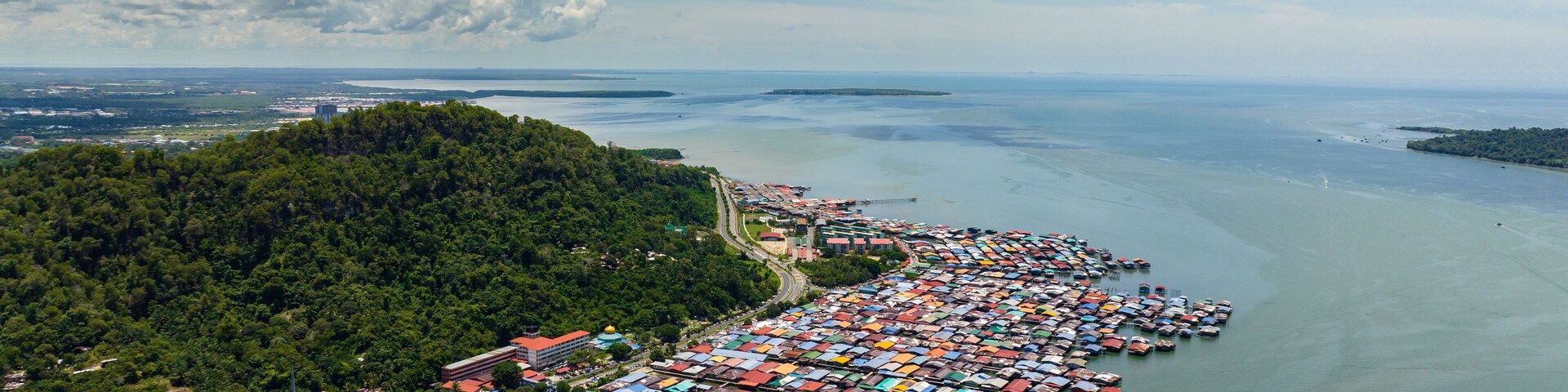 Top view of fishing village with wooden houses on stilts in the sea. Sandakan, Borneo. Malaysia.
