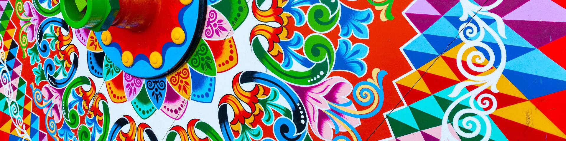 A colorful mural with geometric patterns and floral designs.