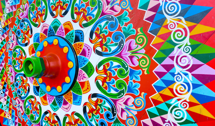A colorful mural with geometric patterns and floral designs.