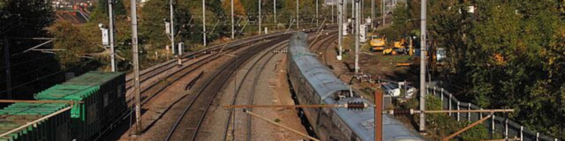 Approaching Cricklewood A view of the St.Pancras mainline from Minster Road. On the left are the last containers on a southbound refuse train. On the right a stopping service from Sutton slows for Cricklewood station, from where it will form the 10:18 departure for Luton.