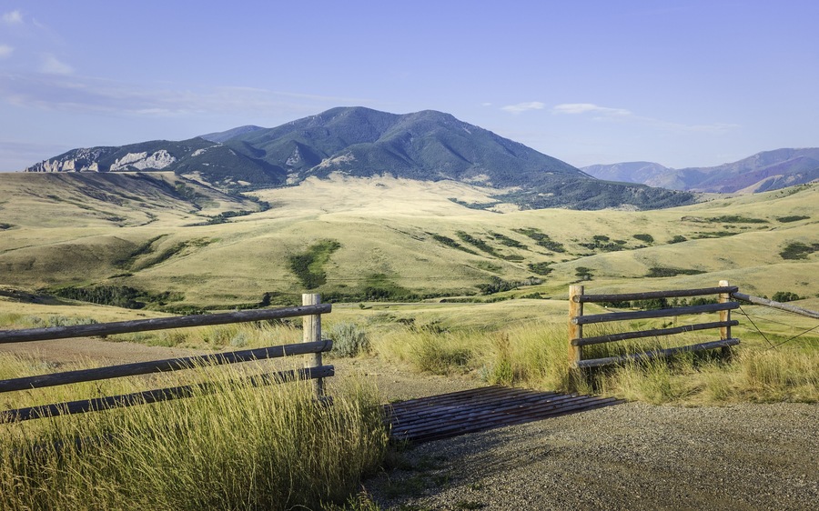 Red Lodge, Montana, USA. Foothills of Bear Tooth Mountains on a summer day with sagebrush and grassland as viewed from the Bear Tooth Mountain pass highway near Red Lodge, Montana, USA.; Shutterstock