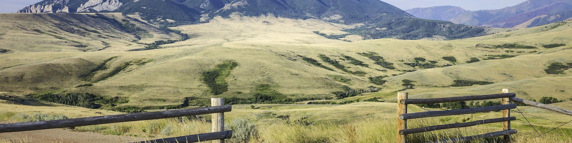 Red Lodge, Montana, USA. Foothills of Bear Tooth Mountains on a summer day with sagebrush and grassland as viewed from the Bear Tooth Mountain pass highway near Red Lodge, Montana, USA.; Shutterstock