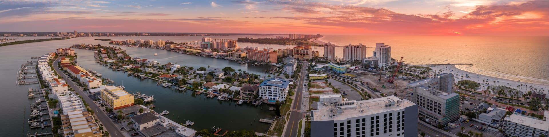 Aerial sunset view of Clearwater beach and Sand key in Western Florida on the Mexican Gulf coast with vacation homes, hotels and bridges connecting