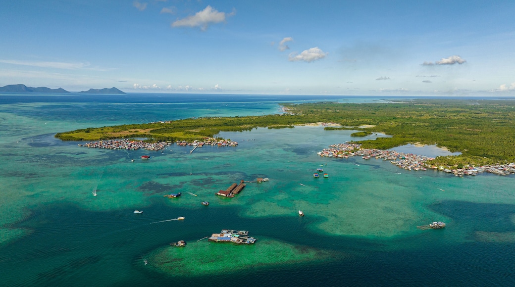 Aerial drone of coast of the island Bum Bum with towns and villages. Semporna, Sabah, Malaysia.