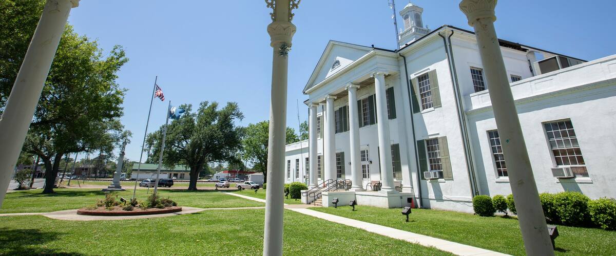 Tallulah, Louisiana, USA - April 23, 2024: Afternoon sun shines on the historic 1887 Madison Parish Courthouse of downtown Tallulah.