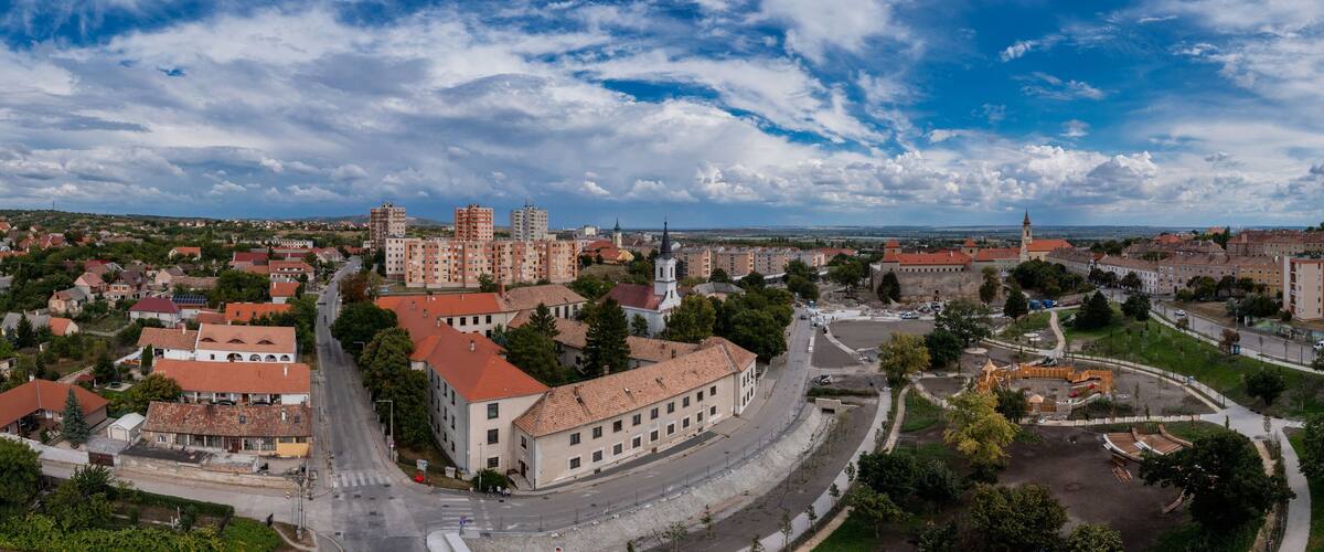 Aerial view of a communist era block house complex build for workers of the heavy industry in the mining town of Varpalota Hungary next to a medieval castle and baroque church