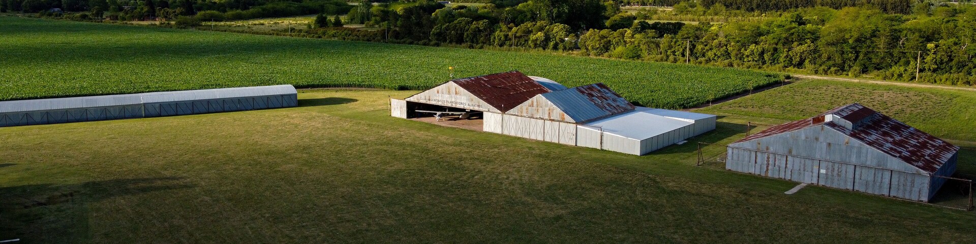 aircraft hangars on a grass runway