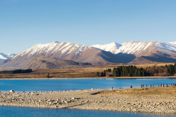 View on picturesque Lake Tekapo with its special blue color. Lake Tekapo is on the South Island of New Zealand, the Mackenzie district, Canterbury Region. Visible is the Church of the Good Shepherd.
