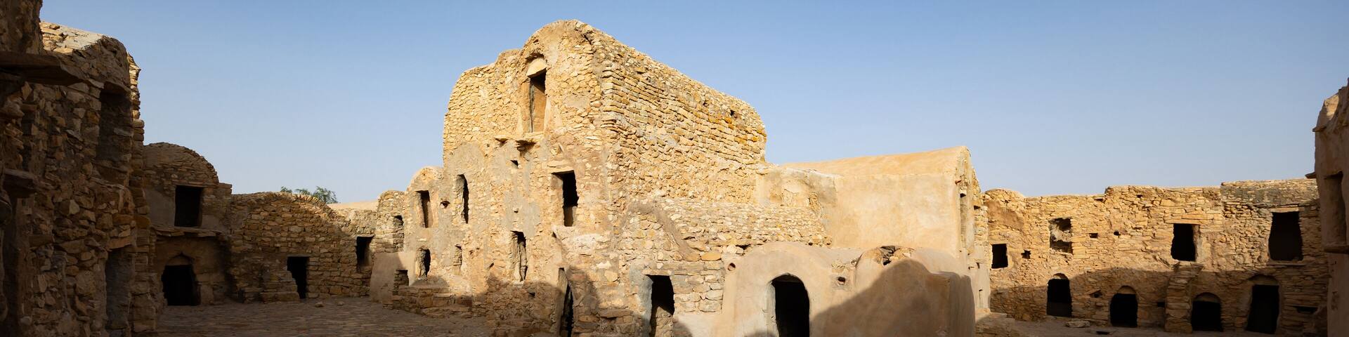 Ruins of ancient abandoned Berber granary structures in Ksar Daghar in Tunisia, standing as testament to traditional North African architecture