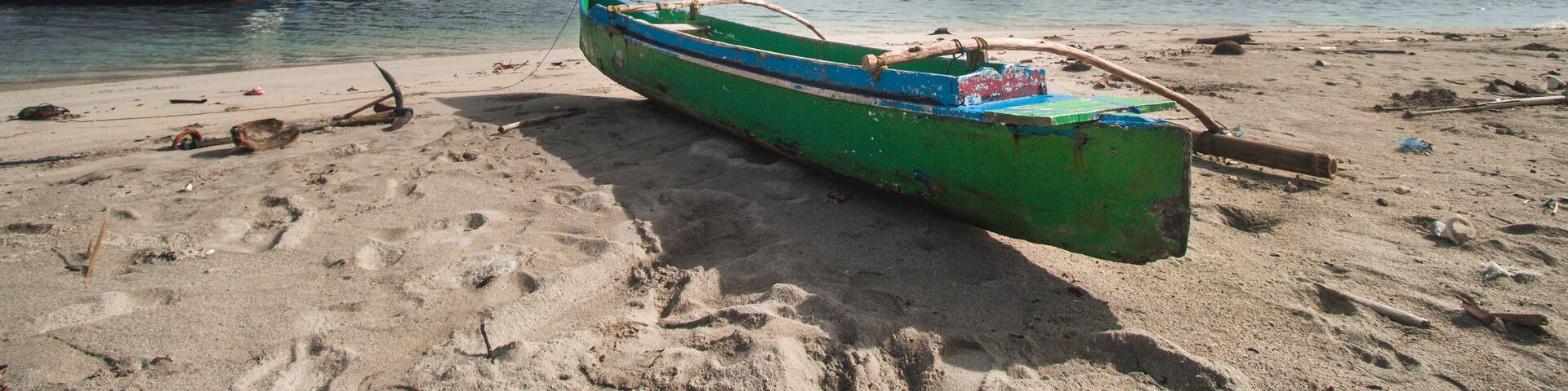 Traditional Wooden Canoe at Beautiful Tropical Beach