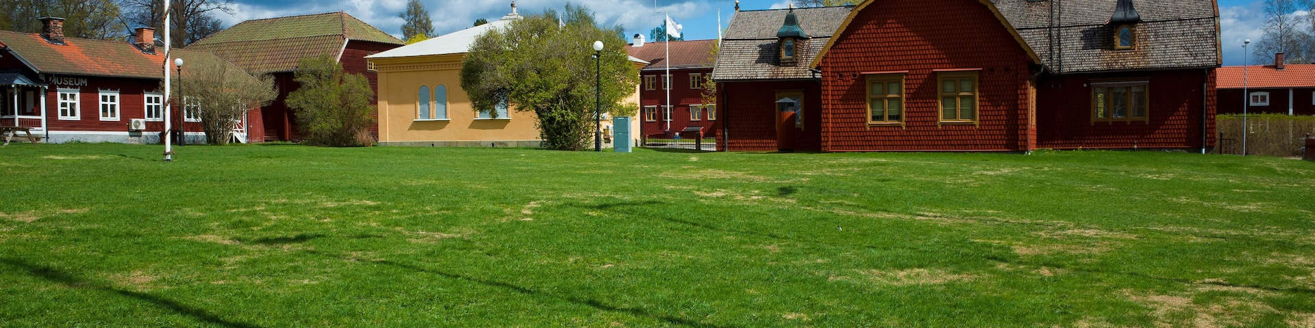 Spacious green lawn overlooking historic buildings, Kopparberg former courthouse originating from 17th century, Old town in Sweden