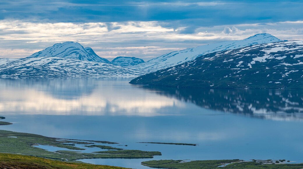 Beautiful Horizontal landscape North of the Arctic Circle in Swedish Lapland overlooking Big lake Vastenjaure on the Padjelanta Trail and The Border to Norway and Fjords reflection in the Water.