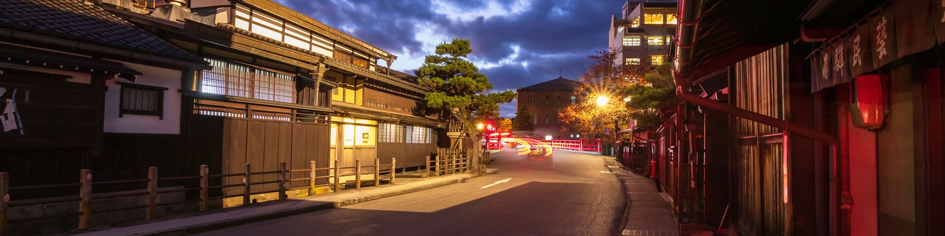 Takayama's historic old town at twilight on night sky. Traditional architecture wooden houses with light up at dusk. Beautiful town in Takayama, Gifu Prefecture, Japan.