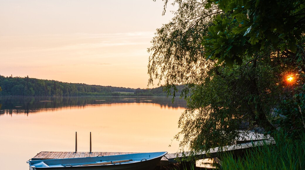Moored boat on still water at sunset. Åtvidaberg, Sweden.
