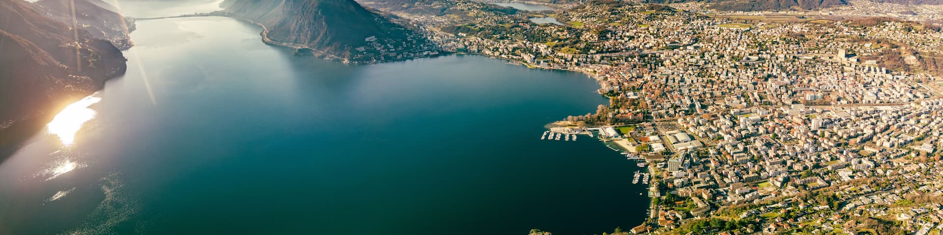 A coastal city with a prominent mountain and a calm bay.