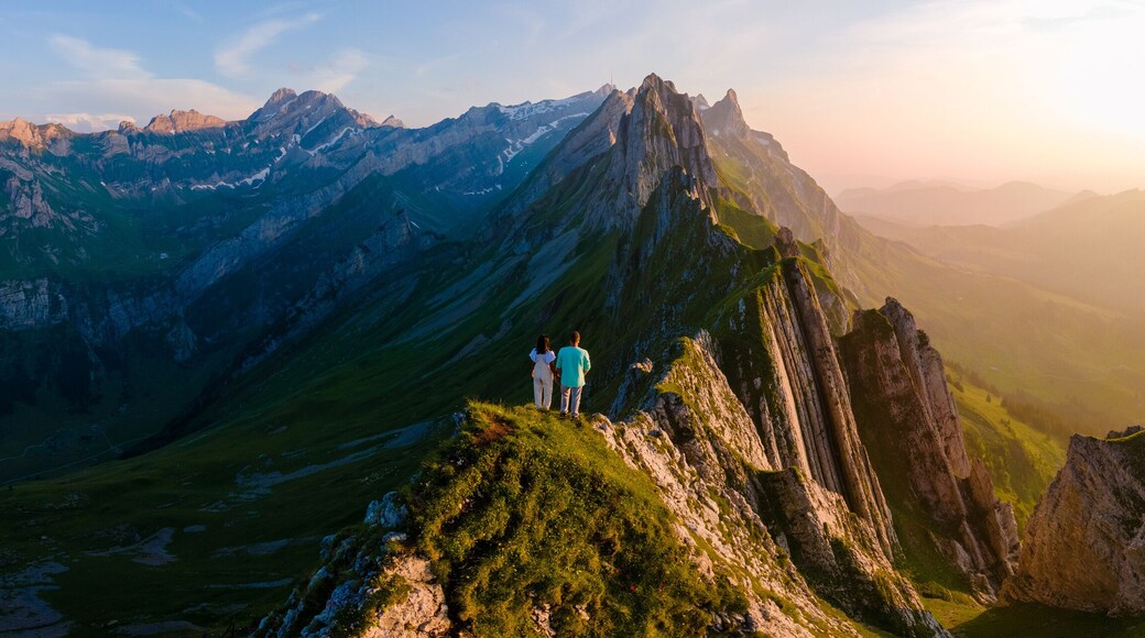 Schaeffler mountain ridge swiss Alpstein, Appenzell Switzerland, a ridge of the majestic Schaeffler peak by Berggasthaus Schafler, Switzerland. couple man and women in the mountains during sunset