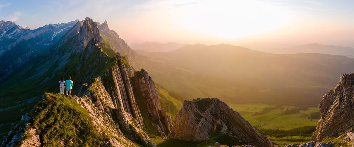 Schaeffler mountain ridge swiss Alpstein, Appenzell Switzerland, a ridge of the majestic Schaeffler peak by Berggasthaus Schafler, Switzerland. couple man and women in the mountains during sunset