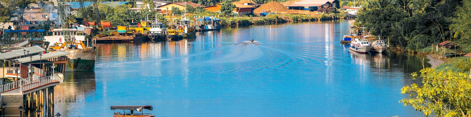Lawas, Sarawak, Malaysia cityscape with river and mountain background