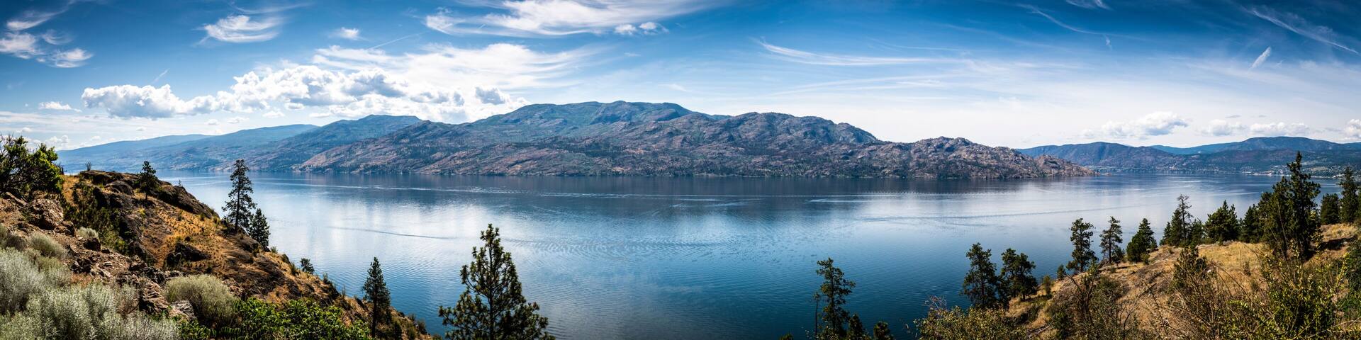 A mountain range, a large lake, and a clear sky.