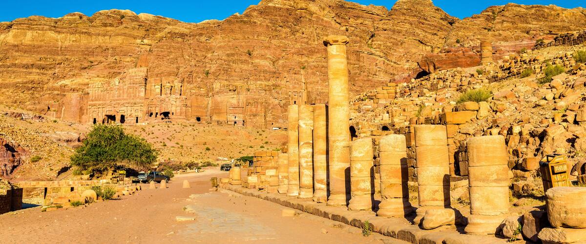 Ancient ruins with columns and a desert landscape.