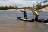 conde, bahia / brazil - march 28, 2013: fishermen are seen in a small boat near the mouth of the Itapicuru river in the district of Siribinha in the city of Conde, north coast of Bahia.