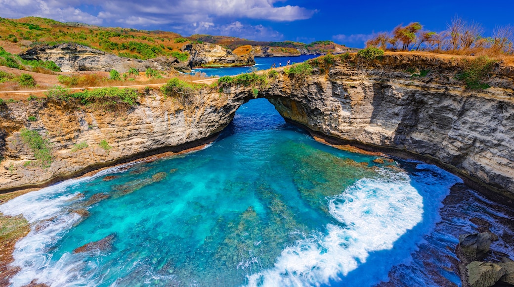 Broken beach and Billabong beach rocky bay with sky blue ocean water and blue sky, eastern in Nusa Penida island, Bali Island, Indonesia.