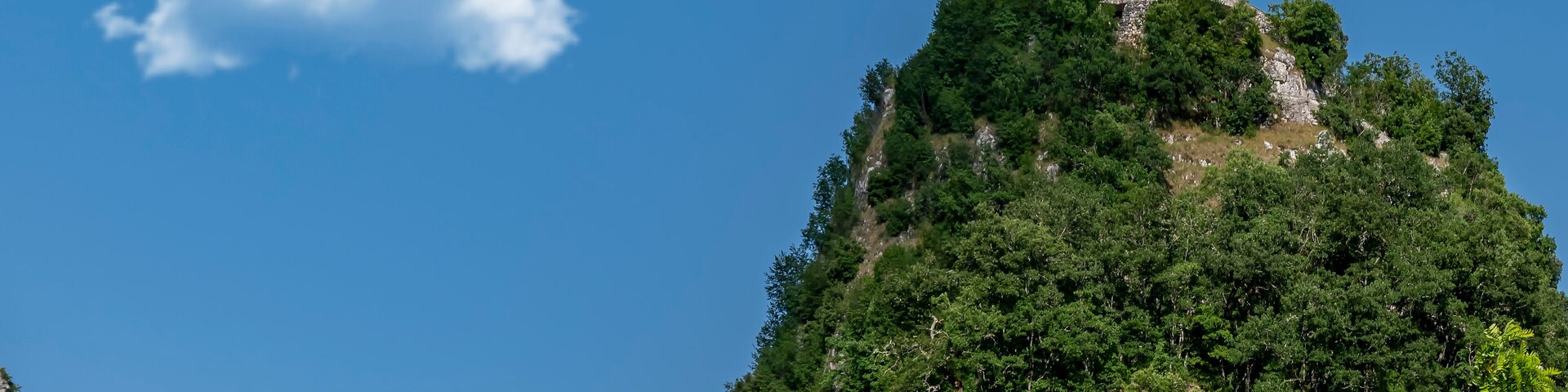 Bottom view of the Rock of Prayer of Roccaporena, Cascia, Italy, or Sacro Scoglio, on a sunny day