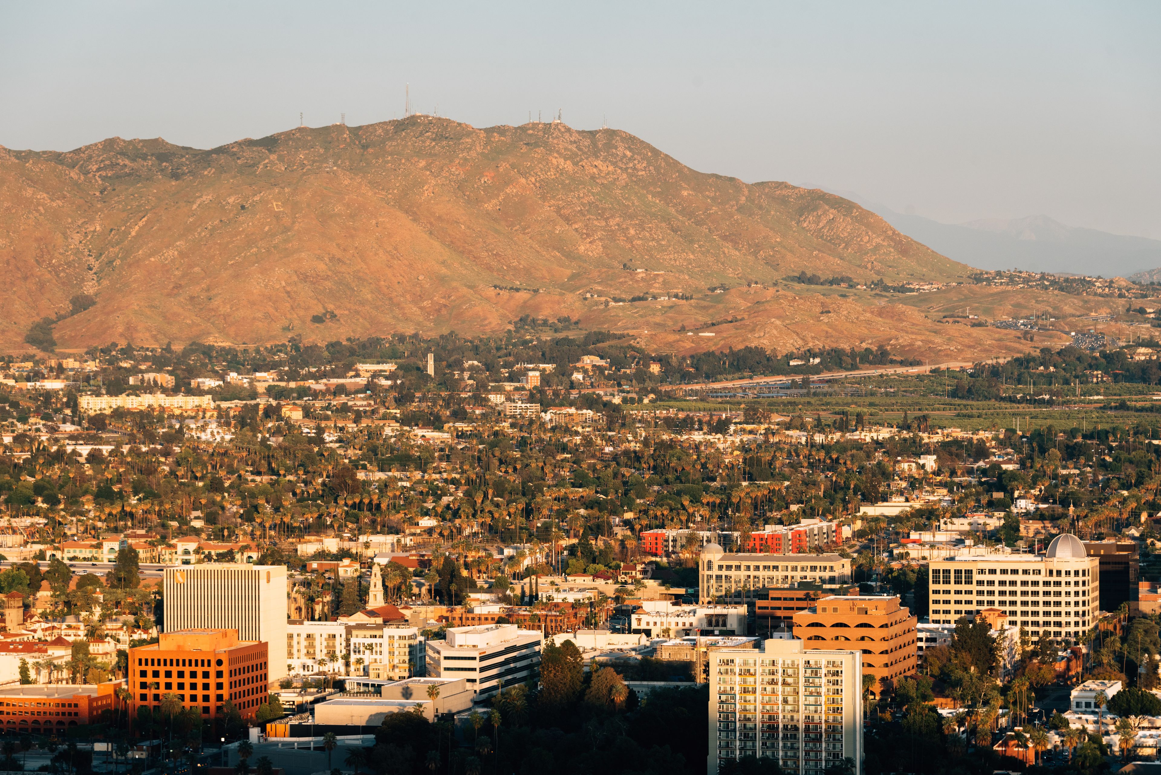 A cityscape with a mountain in the background.