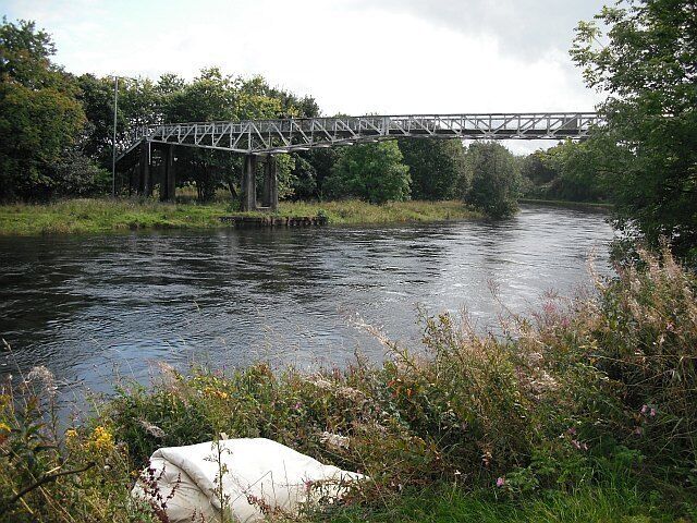 River Leven Running past an abandoned mattress in Renton. The bridge is a footbridge connecting Renton with the Vale of Leven Industrial Estate.