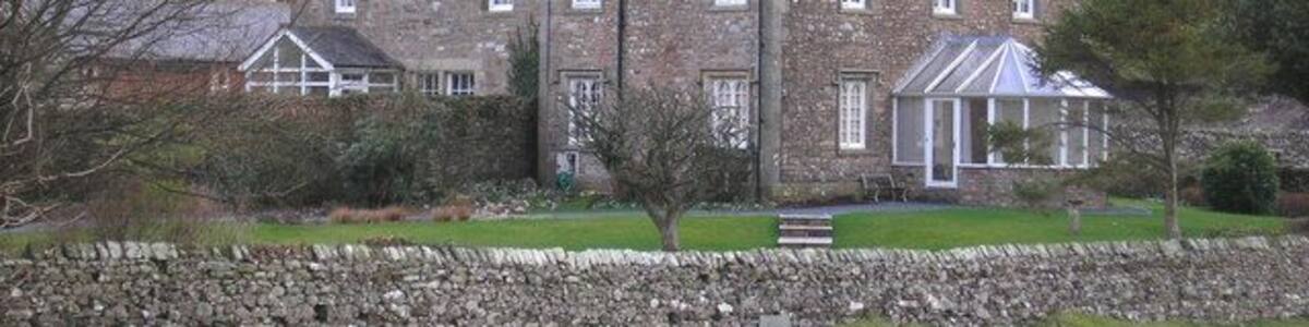 Old Manor An old house in Casterton with Barbon Fell behind.