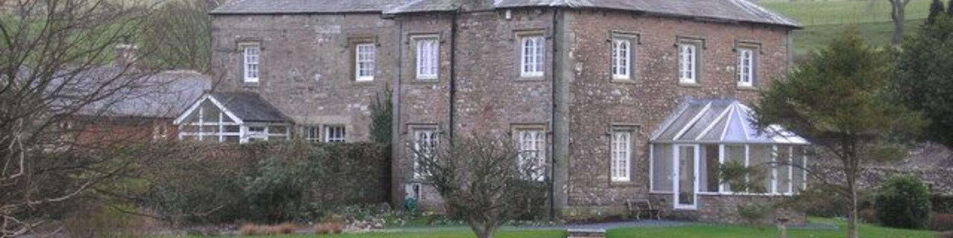 Old Manor An old house in Casterton with Barbon Fell behind.