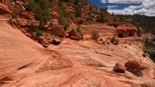 hiking the slick rock out to the man-made kanab sand caves along utah state highway 89. north of kanab, utah, on a sunny summer day