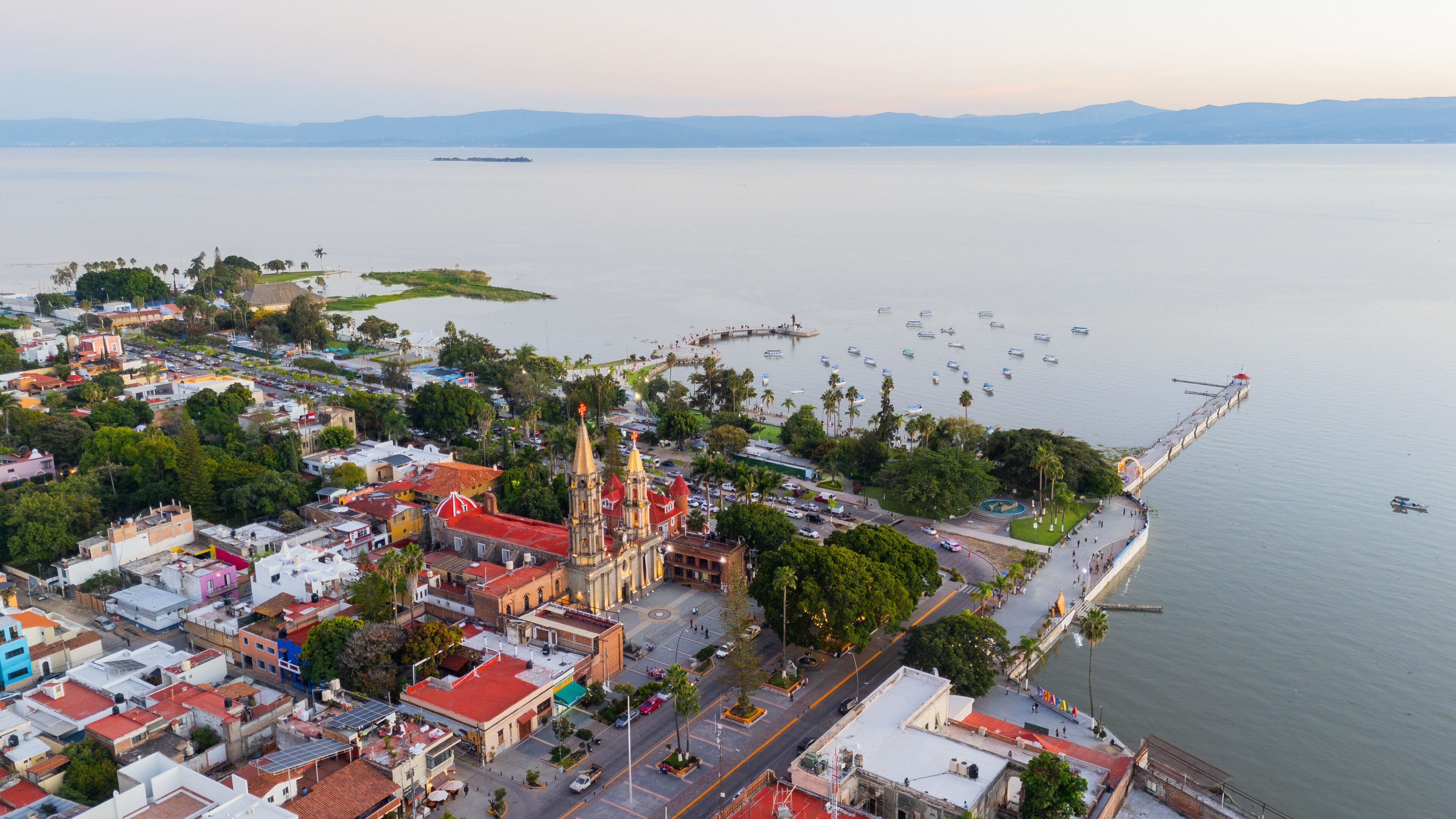 Aerial view of Chapala at sunset with its historic center and pier along the lake. Jalisco, Mexico