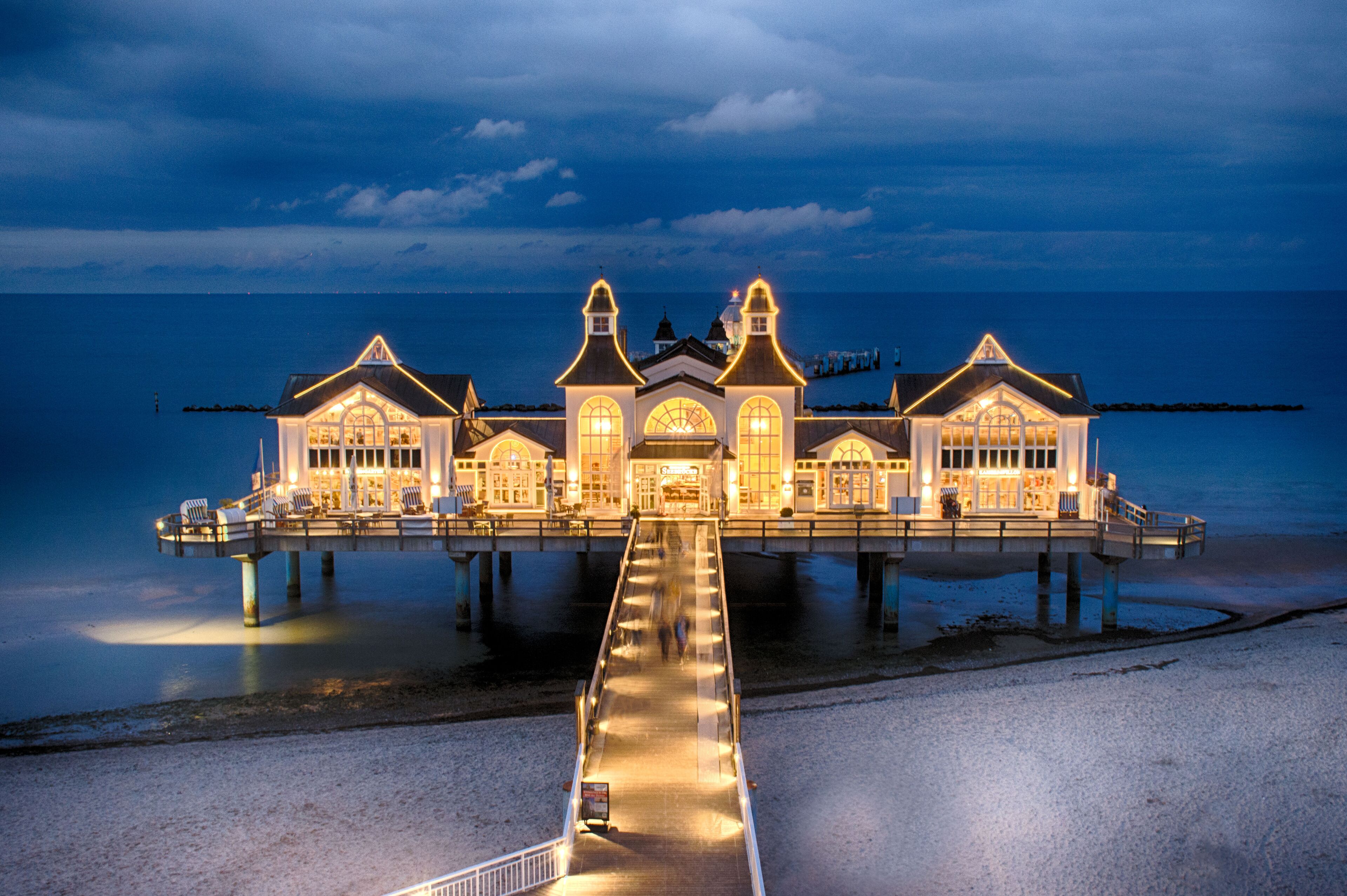 A waterfront building with a pier extending into the water.