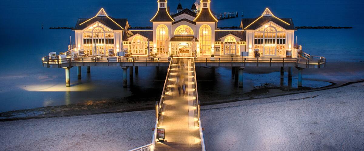 A waterfront building with a pier extending into the water.