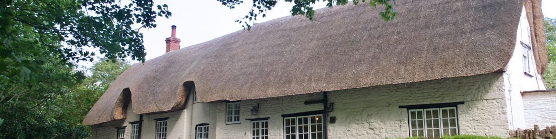 Traditional English thatched cottage in Alderton, Northamptonshire.