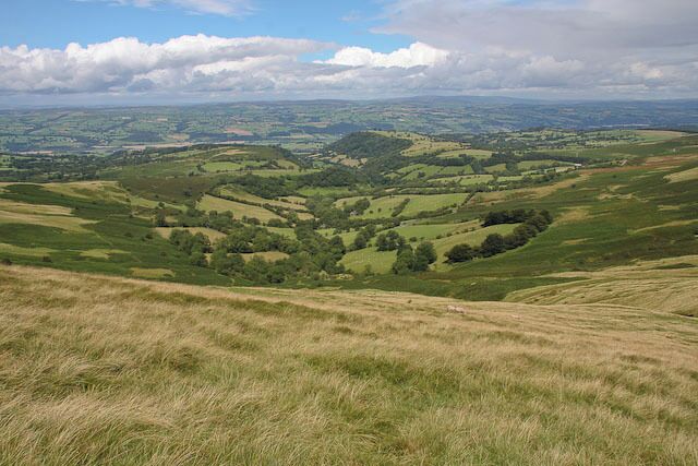 Rolling hills, green fields, and distant valleys.