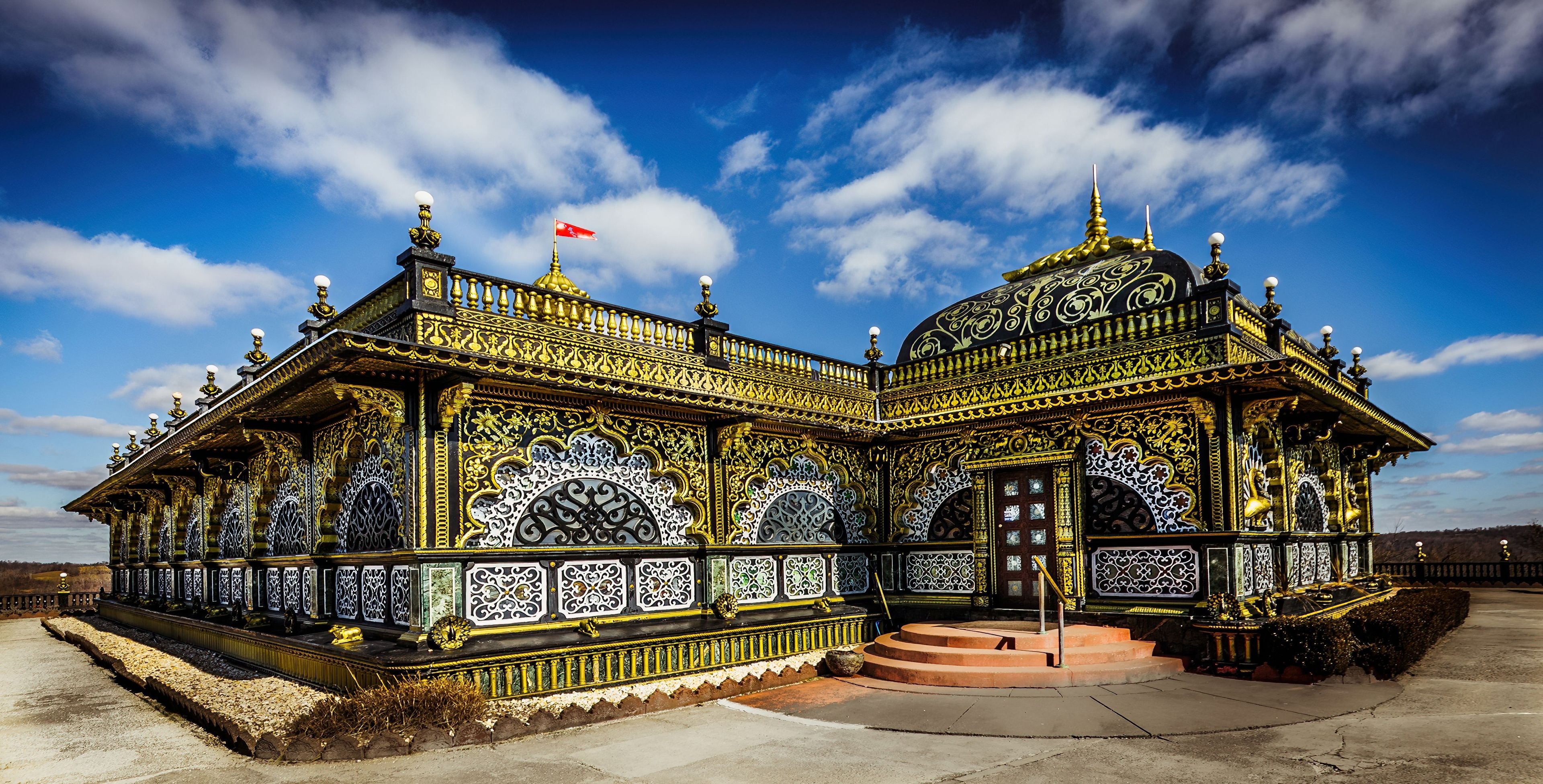 A richly decorated pavilion with intricate patterns and a flag.